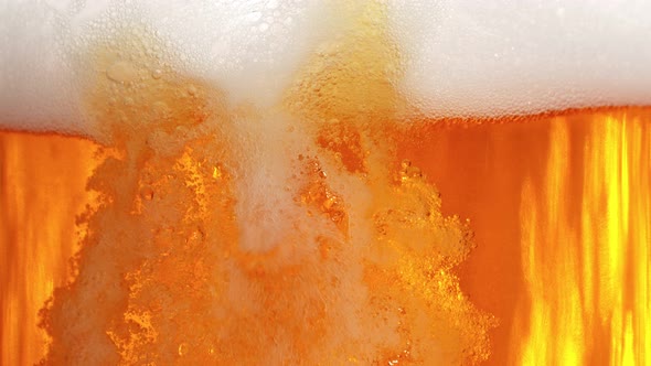 Super Slow Motion Shot of Pouring Fresh Beer Into Glass with Foam at 1000Fps alt