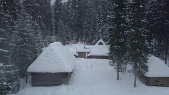 Flying Over Wooden Houses in Winter alt