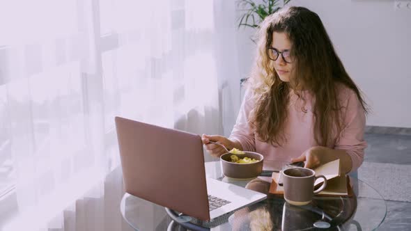 Lady Eat Cereal at Small Table in Sunny Morning