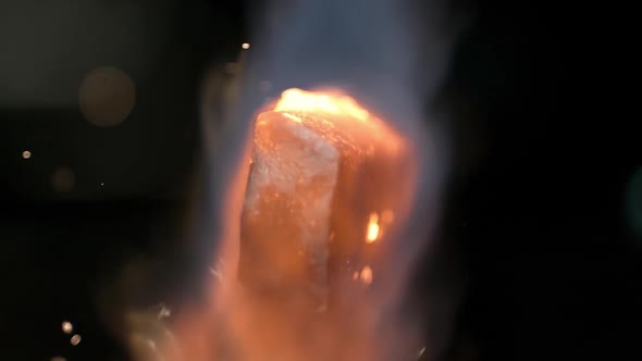 Slow motion of torch heating up piece of metal alt