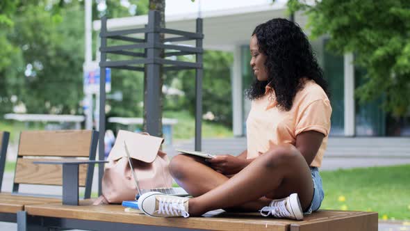 African Student Girl with Laptop and Books in City alt