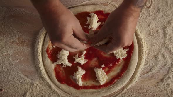 Man Cook Making Pizza Pepperoni on Flour Board Kitchen Table at Restaurant alt
