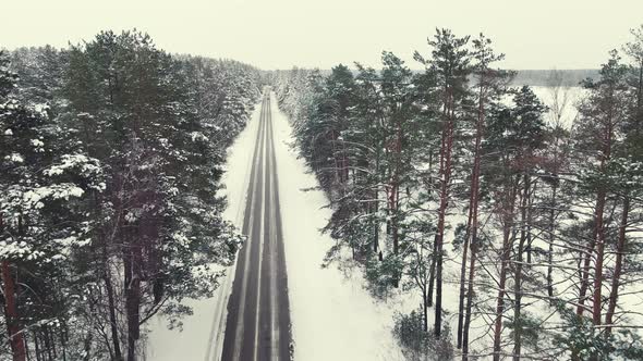 Fabulous Winter Landscape Aerial View Narrow Road in the Forest alt