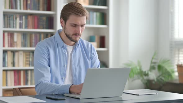 Man Working on Laptop in Office alt