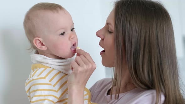 Mom Puts Vitamin in the Childs Mouth alt