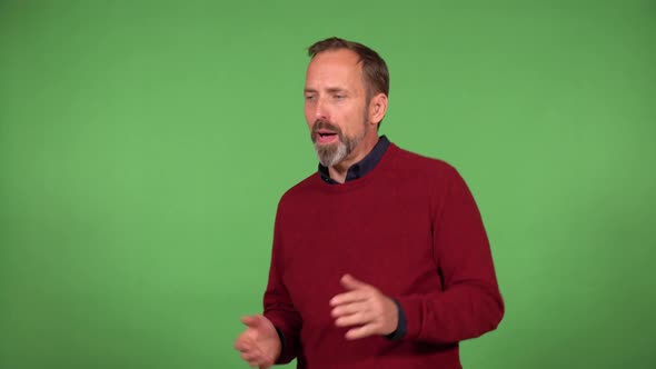 A Middleaged Handsome Caucasian Man Dances with a Smile  Green Screen Background