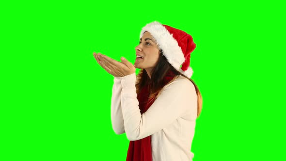 Woman in santa hat and warm clothing blowing over hands alt