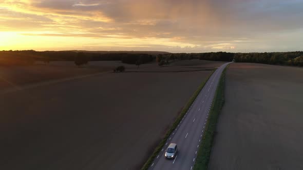 Drone Shot Flying Over Country Road at Sunset