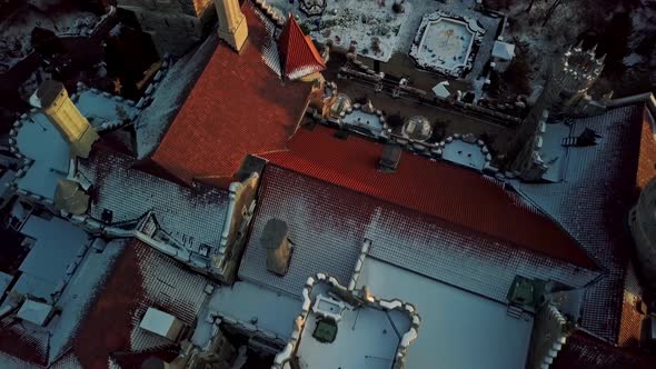 Fresh Snow on the Red Tile Roof of an Old Castle, Drone Tilt Dolly Out. Exciting aerial shot of Casa alt