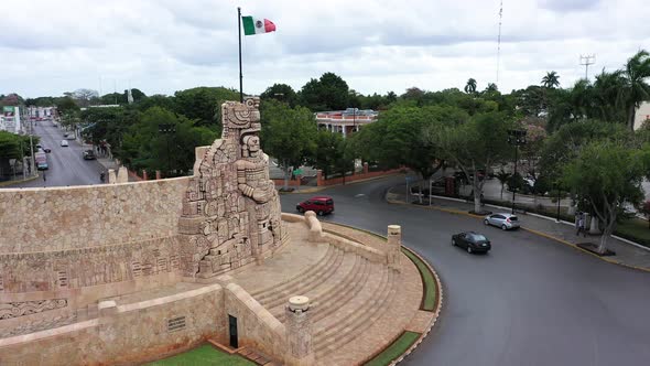 Aerial ascent and camera pitch down of the Monument a la Patria, Homeland Monument with Mexican flag alt