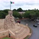 Aerial ascent and camera pitch down of the Monument a la Patria, Homeland Monument with Mexican flag - VideoHive Item for Sale