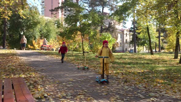 Little Cute Preschool Minor Baby Siblings Girl and Boy Picnic On Red Plaid Yellow Fallen Leaves In alt