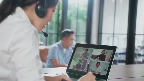Asian business woman mom talk to colleague team about plan in video conference with family at home. alt