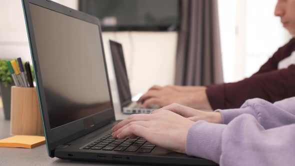 Focused Young freelancer couple sitting at desk working at home. Freelance, home office, remote work alt