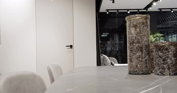 Modern Showroom with Marble Table and White Door alt