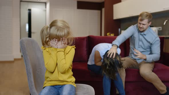Child Girl Kid Is Suffering and Crying From Quarrels Between Parents in Family. Conflict, Problems alt