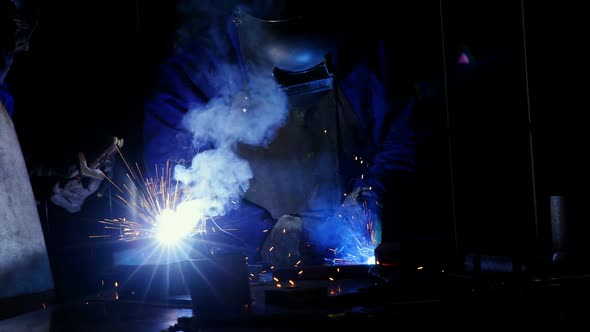 Welder welding a metal alt