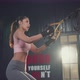 Asian young athlete woman doing cardio exercise and squatting with rope system in  fitness gym.