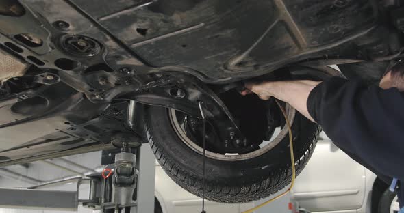 Mechanic Draining Old Brake Fluid From A System During The Service. Close Up alt