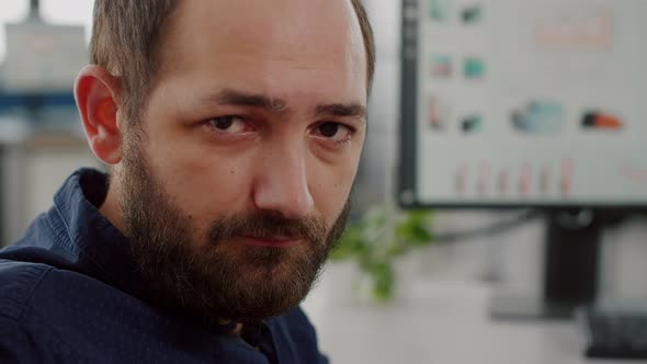 Disabled Business Manager Immobilized in Wheelchair Looking Tired at Camera alt