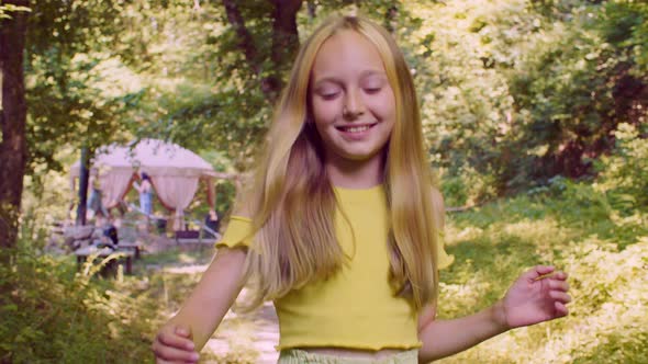 Beautiful Happy Teenage Girl Walking in Summer Forest