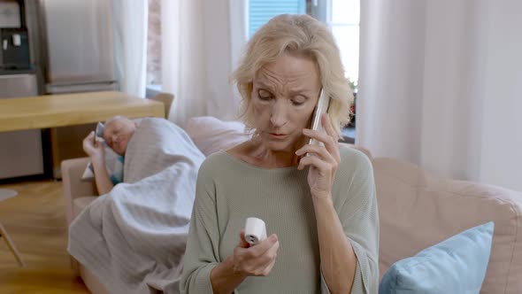 Aged Lady Calling Doctor on Phone Talking About Sick Husband Suffering From Fever alt