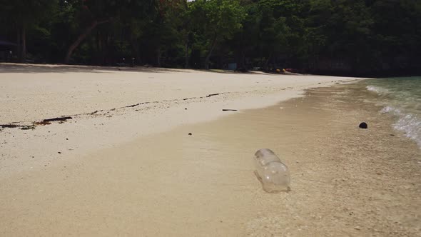 Rubbish on Beach, Single Use Plastic Bottle in Waves on Sandy Shore of White Sand, Garbage Trash and alt