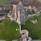 Color contrast of green hill and Corfe castle ruins in county Dorset, England. Aerial drone circling - VideoHive Item for Sale