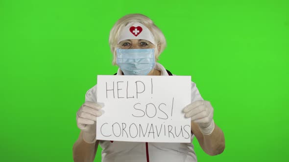Elderly Female Doctor in Medical Mask Show Page with Message. Coronavirus alt
