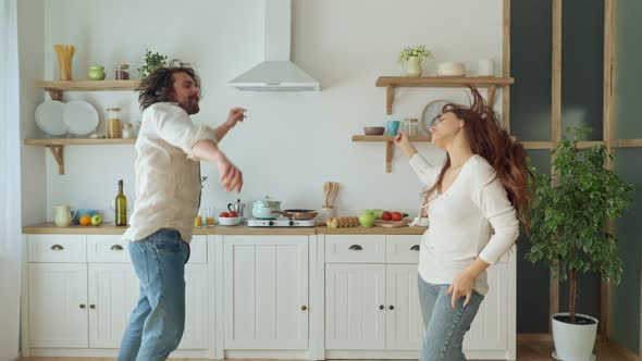 Lovely Couple Having a Fun Together While Dancing at the Bright Kitchen. alt