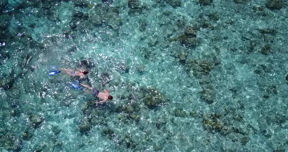 Fun man and woman on romantic honeymoon spend quality time on beach on sunny white sandy  alt