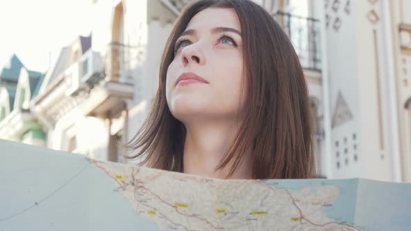 Cropped Shot of a Beautiful Woman Looking Around Using a Map in the City