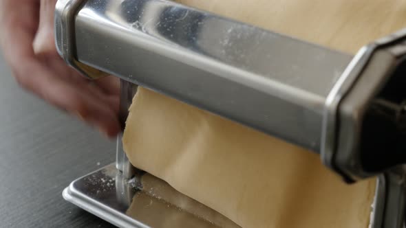 Using of manual pasta machine at home close-up 4K 2160p 30fps UltraHD footage - Italian lasagne maki