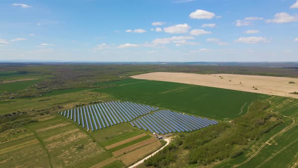 Aerial view of big sustainable electric power plant with many rows of solar photovoltaic panels for alt