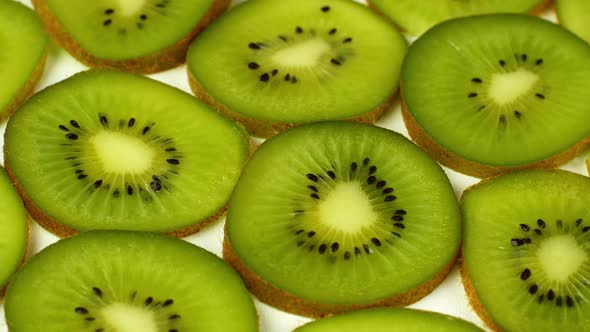 Top view Rotate of Transparent Slice of kiwi fruit on white background, Close up fresh kiwi sliced alt
