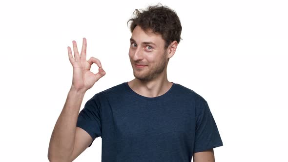Portrait of Positive Young Man Showing Ok Symbol Meaning Good Successful Result or Choice Isolated alt