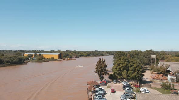 Lujan River With Brown Muddy Water At Daytime In Buenos Aires, Argentina. - aerial alt
