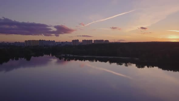 Flight Over the Lake During Sunset Overlooking the City with Beautiful Clouds Ukraine Kiev