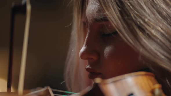 Inspired Female Musician is Playing Violin in Music School Portrait of Woman with Fiddle alt