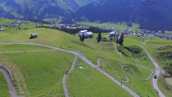 Aerial view of a mountain biker on a scenic singletrack trail alt
