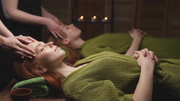 Professional Massage Therapist Gives Head Massage to Two Women