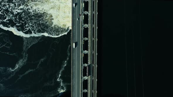 Aerial View of the Bridge Over the River, the Dam. Bubbling Waves on the Water, a Beautiful