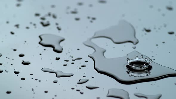 Water drip into puddle closeup , slow motion, shot on Phantom Flex 4K alt