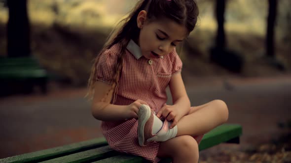 Kid  Sitting And Tying Sneakers Shoes. Preschool Girl Changing Shoes Before Playing With Father. alt