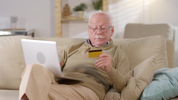 Retired Man Shopping on Laptop Computer alt