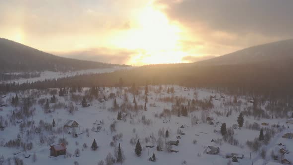 Aerial View of Snowfall in the Village at Sunset. Sheregesh, Russia.