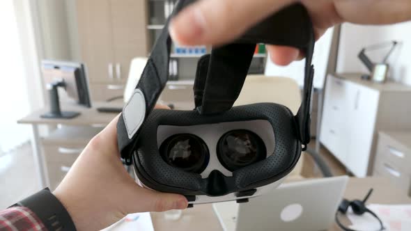 Man Hands Put a Virtual Reality Headset on alt