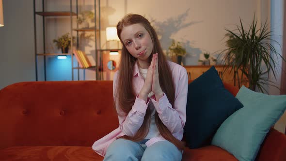 Young Redhead Child Girl Praying Sincerely with Folded Arms Asking God for Help Begging Apology alt