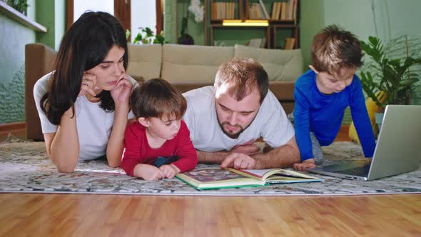 Young Mam and Dad Spending Time at Home with Their alt