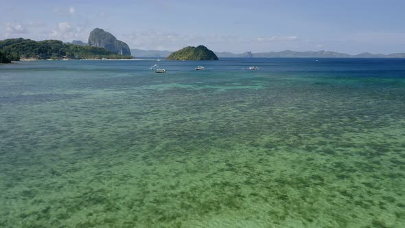 El Nido Palawan Island Philippines Aerial Drone View of Boats Anchored in the Bay with Clear Emerald alt